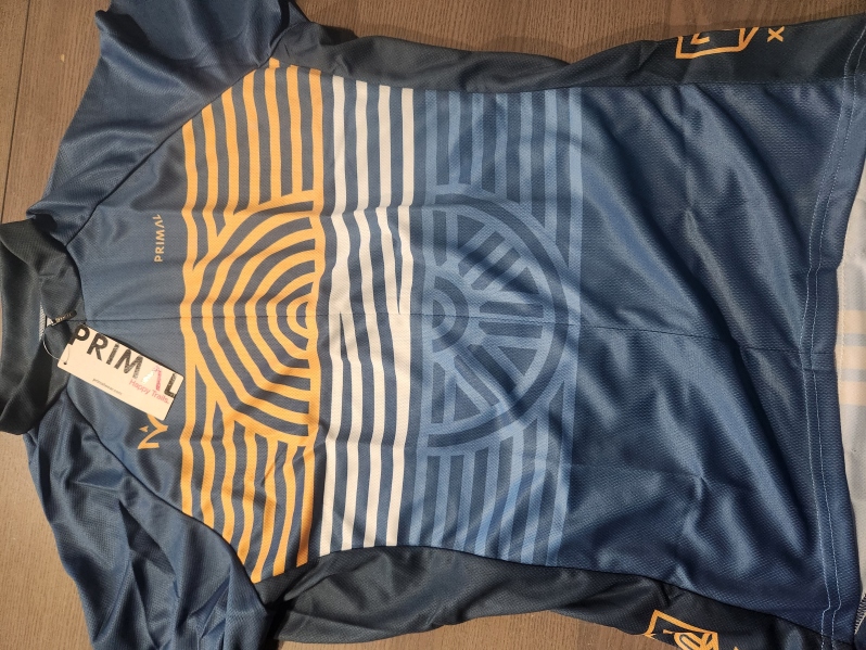Product Description: All Michigander jerseys are crafted with elite fabrics and advanced fit technology to provide the most comfortable riding experience. Utilizingindustry-leading fabric, these jerseys are designed to wick moisture from the surface of the skin and push it to the face of the jersey where it quickly evaporates.</br></br>Please consult Primal'ssizing guide(standard fit) before placing your order.</br></br>Features:</br></br>Raglan style sleeves,sleeveless or tank</br>Full length zip-up</br>Three rearcargo pockets</br>Elastic at sleeve cuff and waist</br> Michigander Jersey 2016 Women's 25th Anniversary
